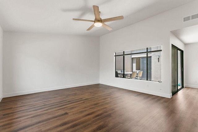 empty room with baseboards, a ceiling fan, dark wood-type flooring, and visible vents