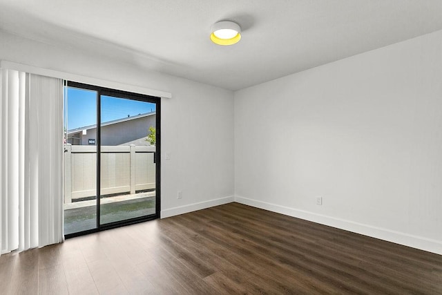 empty room with baseboards and wood finished floors