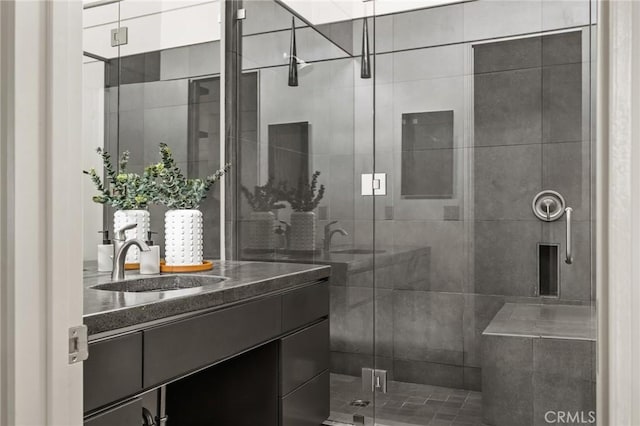 bathroom featuring a shower stall and vanity