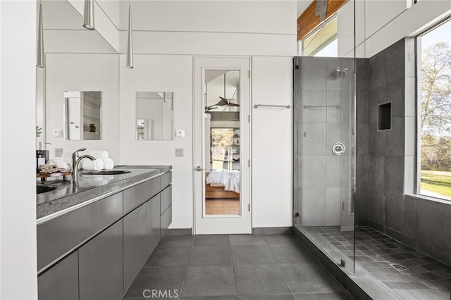 ensuite bathroom with a tile shower, plenty of natural light, ensuite bath, and tile patterned flooring