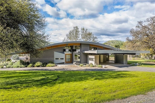 exterior space featuring a front yard and stucco siding