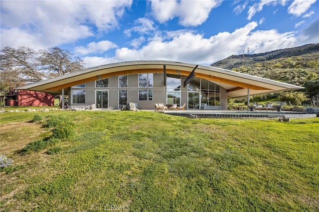 rear view of property featuring a yard