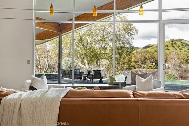 sunroom with plenty of natural light and a mountain view