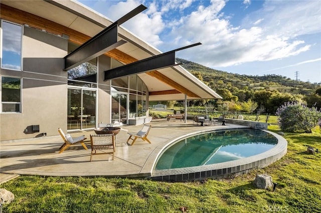 outdoor pool featuring a patio