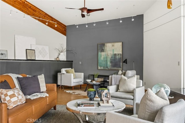 living room featuring track lighting, ceiling fan, and wood finished floors