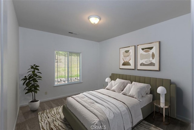 bedroom featuring baseboards, visible vents, and carpet flooring