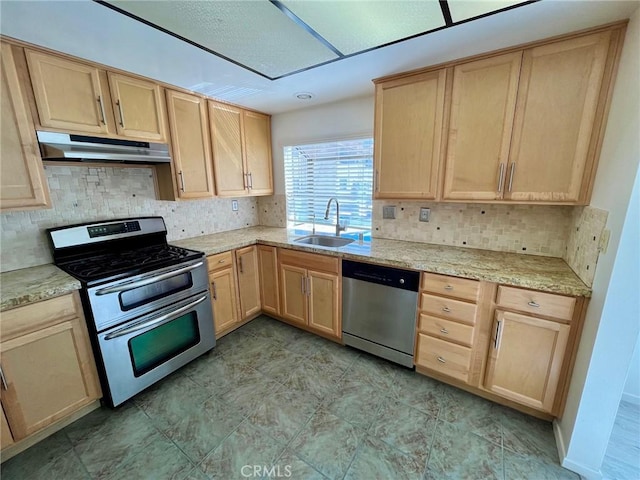 5444 Las Virgenes Rd, Calabasas, CA 91302 - kitchen with under cabinet range hood, light brown cabinets, and appliances with stainless steel finishes