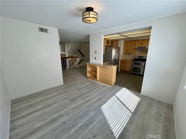 5444 Las Virgenes Rd, Calabasas, CA 91302 - kitchen featuring open shelves, light wood-type flooring, stainless steel appliances, under cabinet range hood, and visible vents