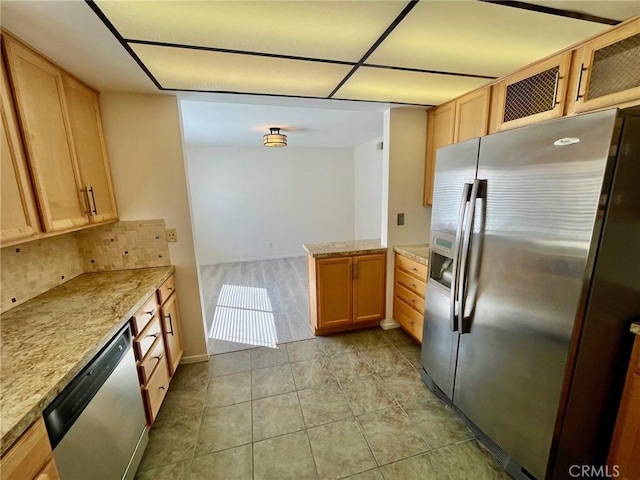 5444 Las Virgenes Rd, Calabasas, CA 91302 - kitchen with a peninsula, tasteful backsplash, stainless steel appliances, and light brown cabinetry