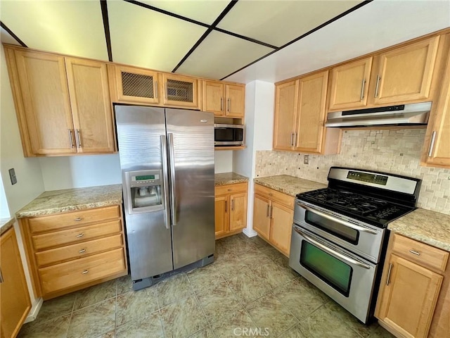 5444 Las Virgenes Rd, Calabasas, CA 91302 - kitchen with backsplash, light brown cabinetry, appliances with stainless steel finishes, and under cabinet range hood