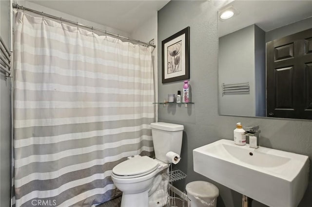 3408 Hathaway Ave Unit 301, Long Beach, CA 90815 - full bathroom with toilet, a sink, a shower with shower curtain, and a textured wall