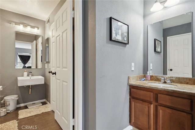 3408 Hathaway Ave Unit 301, Long Beach, CA 90815 - bathroom with wood finished floors, a sink, and a textured wall