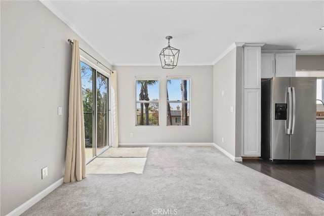 3408 Hathaway Ave Unit 301, Long Beach, CA 90815 - unfurnished dining area featuring crown molding, baseboards, dark colored carpet, and a chandelier