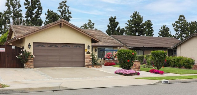 10629 El Este Ave, Fountain Valley, CA 92708 - ranch-style house with a garage, driveway, stone siding, and stucco siding