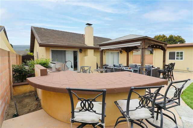 10629 El Este Ave, Fountain Valley, CA 92708 - rear view of property with stucco siding, outdoor dry bar, fence, and a chimney