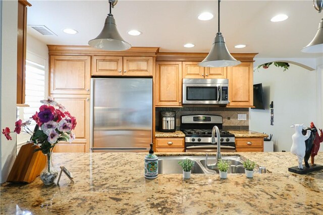 10629 El Este Ave, Fountain Valley, CA 92708 - kitchen featuring visible vents, decorative backsplash, light stone counters, appliances with stainless steel finishes, and hanging light fixtures