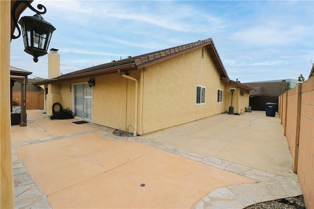 10629 El Este Ave, Fountain Valley, CA 92708 - rear view of property with a patio area, a fenced backyard, a chimney, and stucco siding