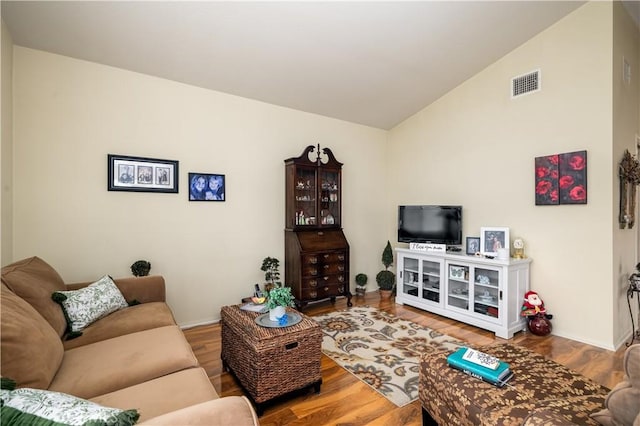 27191 Ryan Dr, Laguna Niguel, CA 92677 - living area with vaulted ceiling, visible vents, and wood finished floors