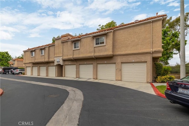 27191 Ryan Dr, Laguna Niguel, CA 92677 - view of property with stucco siding and community garages