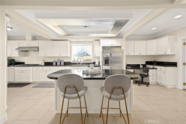2700 Holly Ave, Arcadia, CA 91007 - kitchen featuring a kitchen breakfast bar, under cabinet range hood, stainless steel fridge with ice dispenser, dark countertops, and crown molding