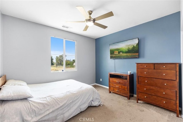 bedroom featuring light colored carpet, baseboards, and ceiling fan