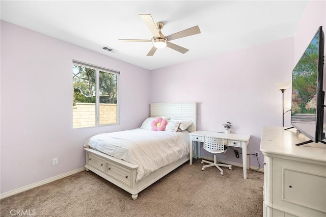bedroom featuring light carpet, baseboards, and ceiling fan
