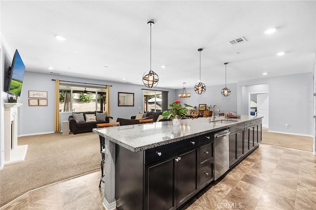 kitchen featuring a sink, dishwasher, recessed lighting, a kitchen island with sink, and open floor plan