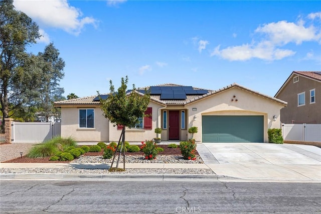 mediterranean / spanish-style house featuring a tiled roof, stucco siding, fence, and a gate