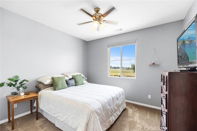 carpeted bedroom with baseboards and a ceiling fan
