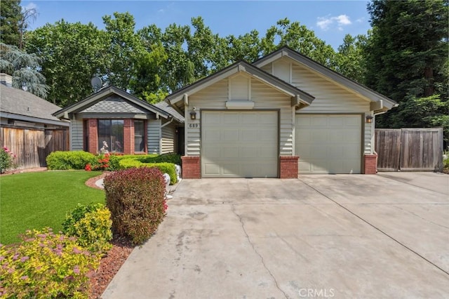 689 E Pintail Cir, Fresno, CA 93730 - single story home with fence, brick siding, concrete driveway, a garage, and a front lawn