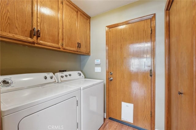 689 E Pintail Cir, Fresno, CA 93730 - laundry area with cabinet space, washing machine and dryer, and light wood-type flooring