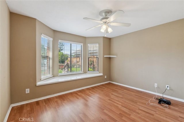 689 E Pintail Cir, Fresno, CA 93730 - unfurnished room with wood finished floors, baseboards, and ceiling fan