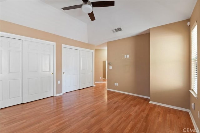689 E Pintail Cir, Fresno, CA 93730 - unfurnished bedroom featuring visible vents, two closets, light wood finished floors, a ceiling fan, and baseboards