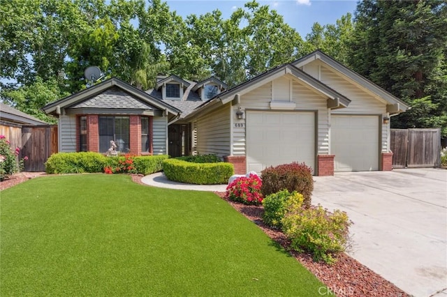 689 E Pintail Cir, Fresno, CA 93730 - view of front of home featuring fence, a front lawn, brick siding, and driveway