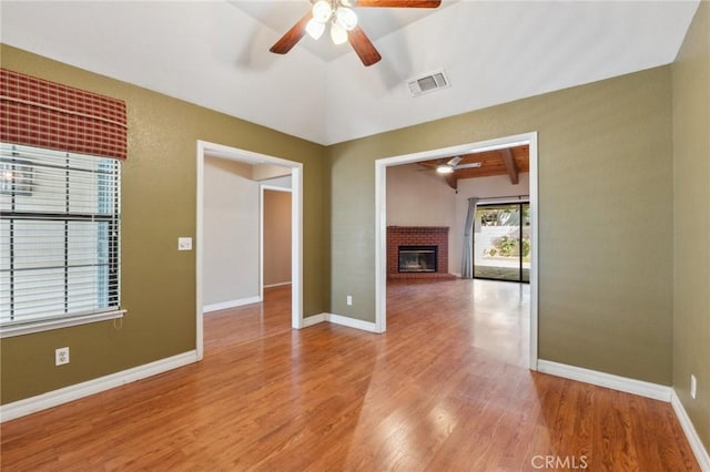 689 E Pintail Cir, Fresno, CA 93730 - unfurnished room featuring visible vents, a brick fireplace, a ceiling fan, baseboards, and light wood-style floors