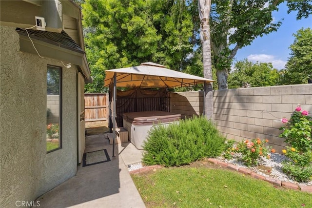 689 E Pintail Cir, Fresno, CA 93730 - view of yard featuring a hot tub, a gazebo, a fenced backyard, and a patio