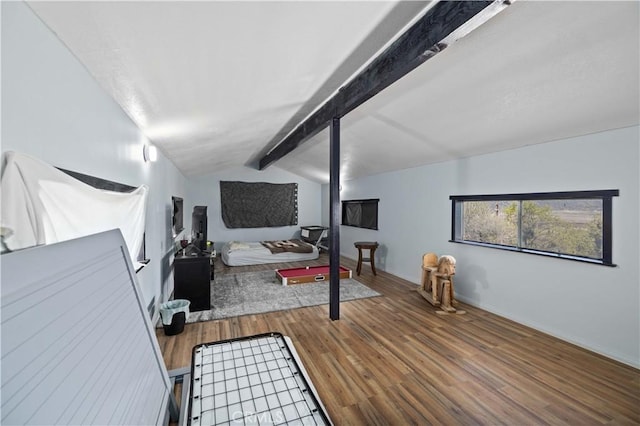 bedroom featuring lofted ceiling with beams and wood finished floors
