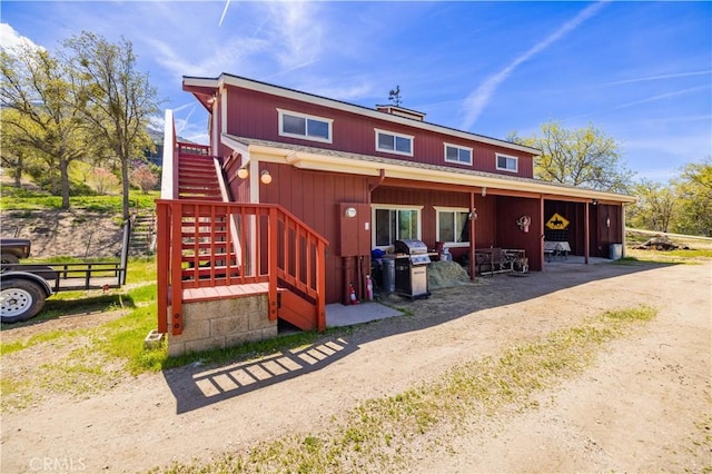 back of house with stairs