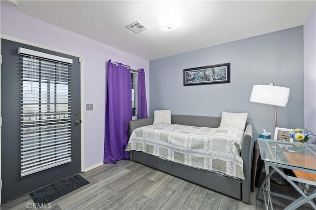 bedroom with wood finished floors and visible vents