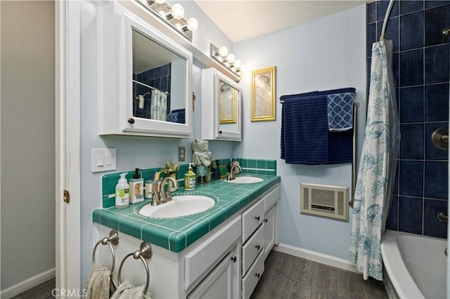 full bath with double vanity, wood finished floors, visible vents, and a sink