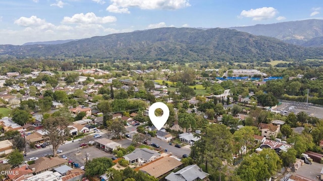 aerial overview of property's location with a mountain backdrop and nearby suburban area