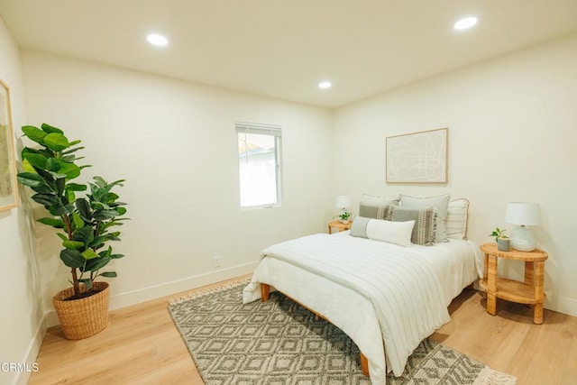 bedroom with light wood-style floors, recessed lighting, and baseboards