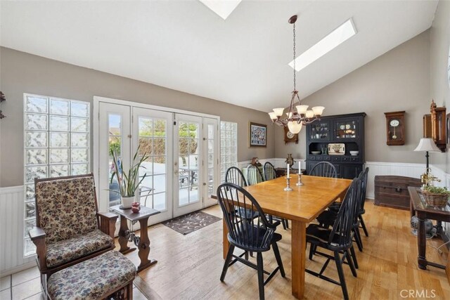 1675 Bridget Ave, Simi Valley, CA 93065 - dining space featuring a wainscoted wall, a chandelier, french doors, a skylight, and light wood-type flooring