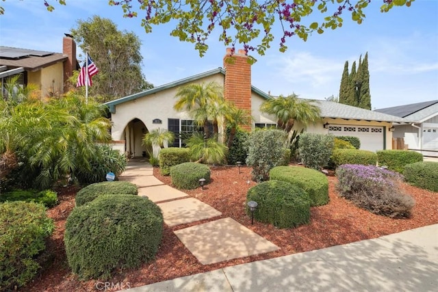 1675 Bridget Ave, Simi Valley, CA 93065 - view of front of property featuring stucco siding, a garage, and a chimney