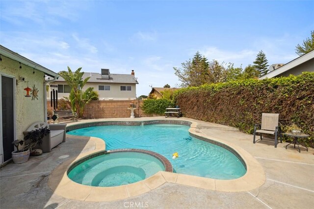 1675 Bridget Ave, Simi Valley, CA 93065 - view of swimming pool with a patio, a pool with connected hot tub, and a fenced backyard