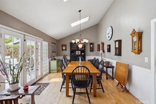 1675 Bridget Ave, Simi Valley, CA 93065 - dining space featuring a chandelier, a skylight, light wood-type flooring, wainscoting, and french doors