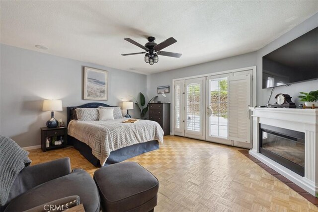 1675 Bridget Ave, Simi Valley, CA 93065 - bedroom with access to outside, a glass covered fireplace, baseboards, ceiling fan, and a textured ceiling