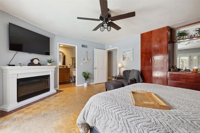1675 Bridget Ave, Simi Valley, CA 93065 - bedroom with a glass covered fireplace, baseboards, a ceiling fan, and ensuite bath