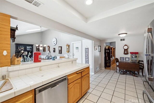 1675 Bridget Ave, Simi Valley, CA 93065 - kitchen featuring stainless steel dishwasher, a chandelier, light tile patterned floors, tile counters, and lofted ceiling
