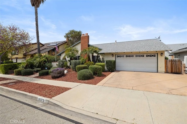 1675 Bridget Ave, Simi Valley, CA 93065 - view of front of house with stucco siding, an attached garage, concrete driveway, a chimney, and a shingled roof